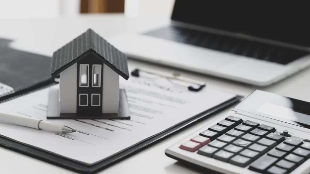 Bali villa legal documents — NIB, KBLI, PBG, and SLF — represented by a pen on contract papers with a small house model